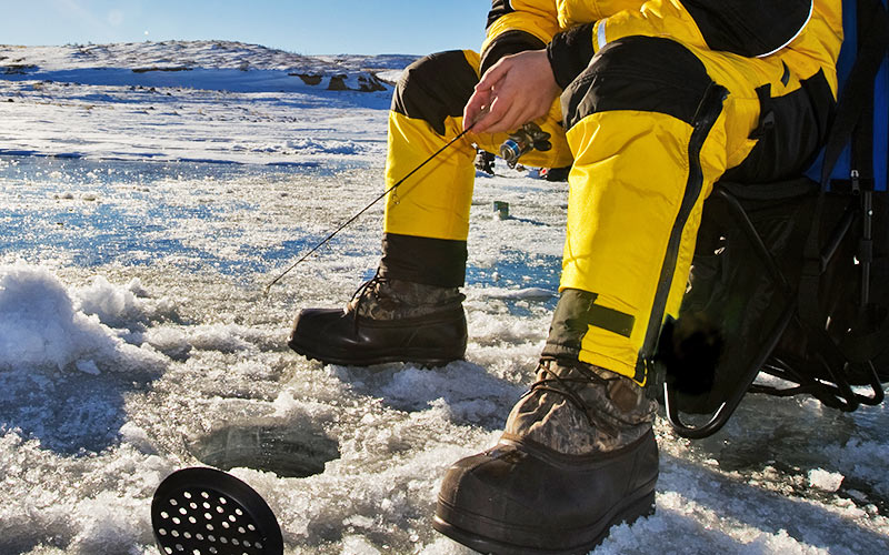 A close up of someone fishing in a hole in some ice