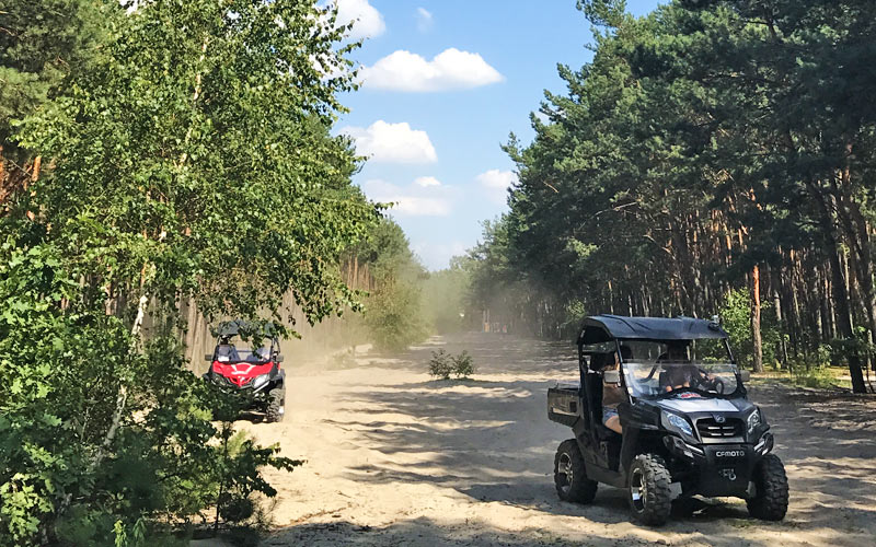 Two 4x4 vehicles on a dirt track