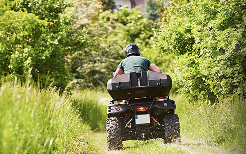The back on a man riding a quad bike