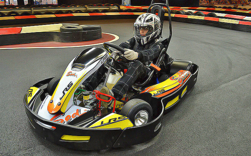Someone driving a go kart, racing around a track