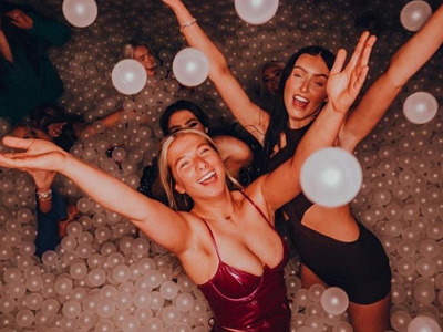 A line of people outside Perdu at night