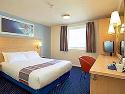 A room within Edinburgh's Travelodge with dark blue carpet