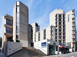 The exterior of Travelodge London Covent Garden against a blue sky