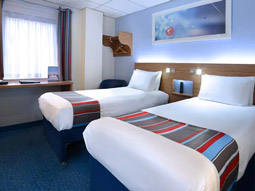 The exterior of the Travelodge Belfast Central, with cars packed outside