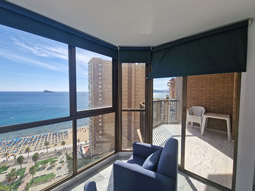 A view of the beach and beach front walkway from a balcony in a room at Apartamentos Oasis in Benidorm