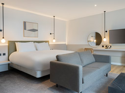 Room with double bed and seating area 