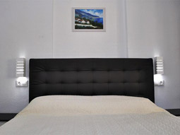 A double bed in a room at Evamar Apartments