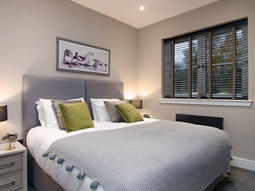 Stylish double bedroom with wall art 