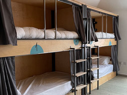 Bunkbeds with curtains around each for privacy at Leevin Hostel George