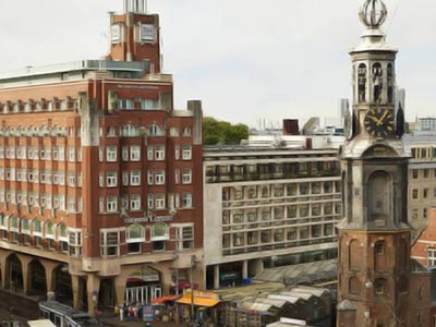 A clock tower in front of the NH Carlton Amsterdam building
