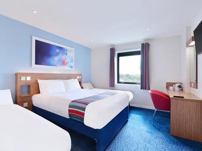 A double bed and a single bed in a Travelodge room