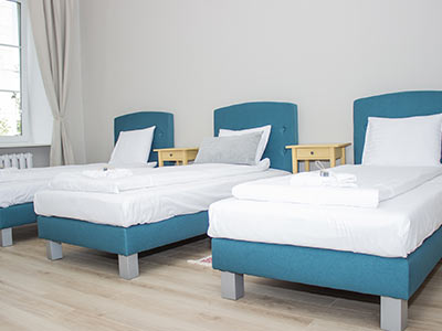 A light room with 3 single beds