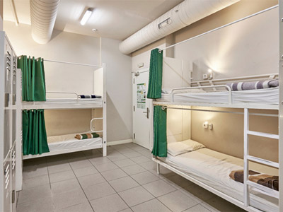 Two sets of bunkbeds with individual curtains on at Hola Hostel in Barcelona