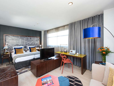 A bedroom with a dressing area and TV at the bottom of the bed at Capri by Fraser Barcelona