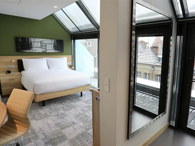 An open plan room with skylights and a large bed at Hampton by Hilton in Gdansk Old Town