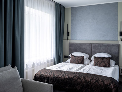 A double bed in a room with a large window at Bellevue Park Hotel - Rank #7