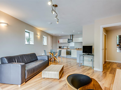 The kitchen, lounge and entertainment area in a room at Roomzzz in Headingley, Leeds