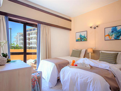 A twin room with a balcony that overlooks the city at Turial Park Apartments in Algarve, Portugal