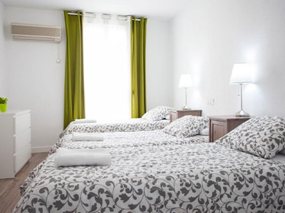 Three single beds in an apartment in Lisbon