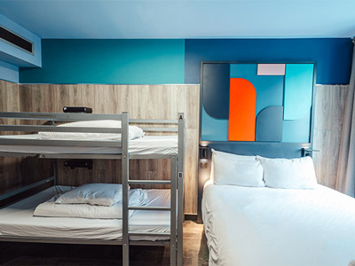 A room with several bunkbeds in and a table to sit at at Kabannas in Newcastle - Rank #9