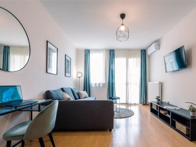 A lounge area with a TV and desk area at Budapest Premium Apartments - Rank #2