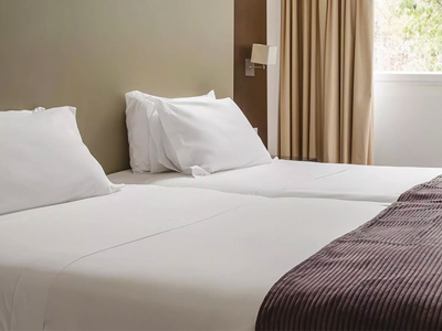 A close up of twin bed in a room at Central Park Hotel Suites & Studio in Lisbon