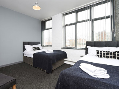 A room with a large window and two beds at 36 Mason Street