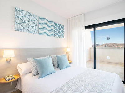 A double bed with a sliding door balcony at Benidorm Horizon