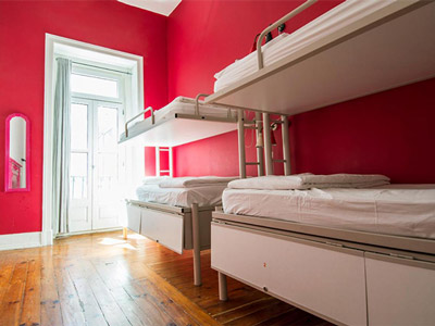 Two bunkbeds in a red room at Safestay Lisbon
