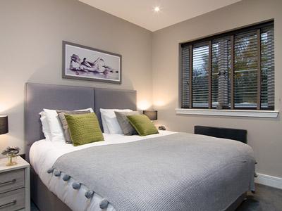 Stylish double bedroom with wall art 