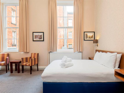 A double bed in a bright room at The Crown Hotel Harrogate