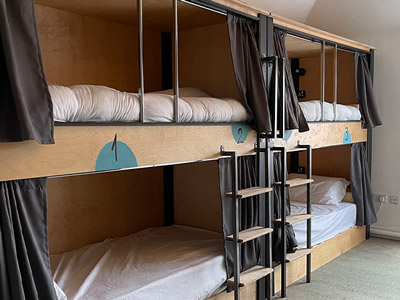 Bunkbeds with curtains around each for privacy at Leevin Hostel George
