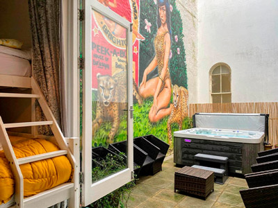 A tropical themed terrace with a hot tub 