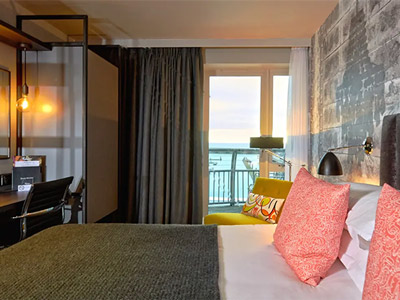 A double bed in a room with a view of the sea at Malmaison in Brighton
