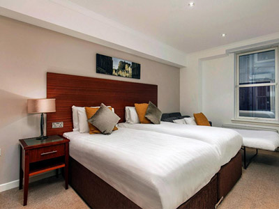 A room with three beds in it 