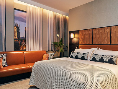 A double bedroom with a sofa and city views of York 