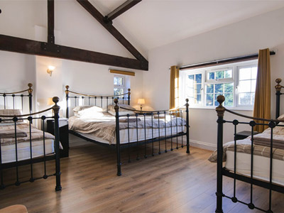 A bedroom at Minster Lodge which has three beds 
