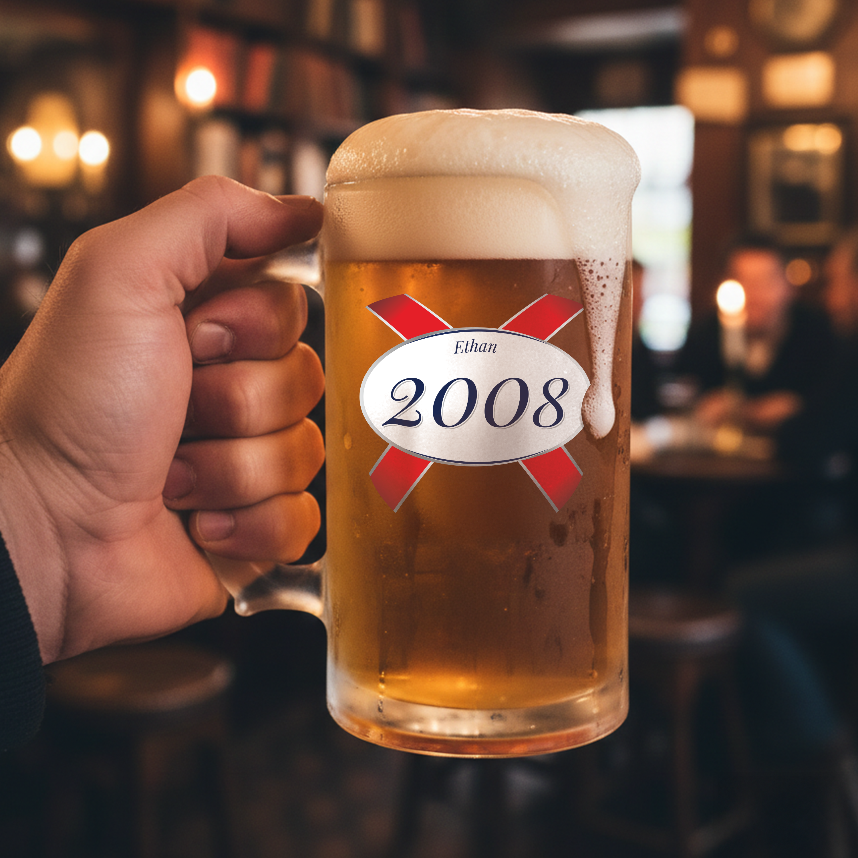 A custom birthday stein with clear glass and a Kronebourg 1664 design where the 1664 has been swapped for 2008 and has the custom text Ethan on it