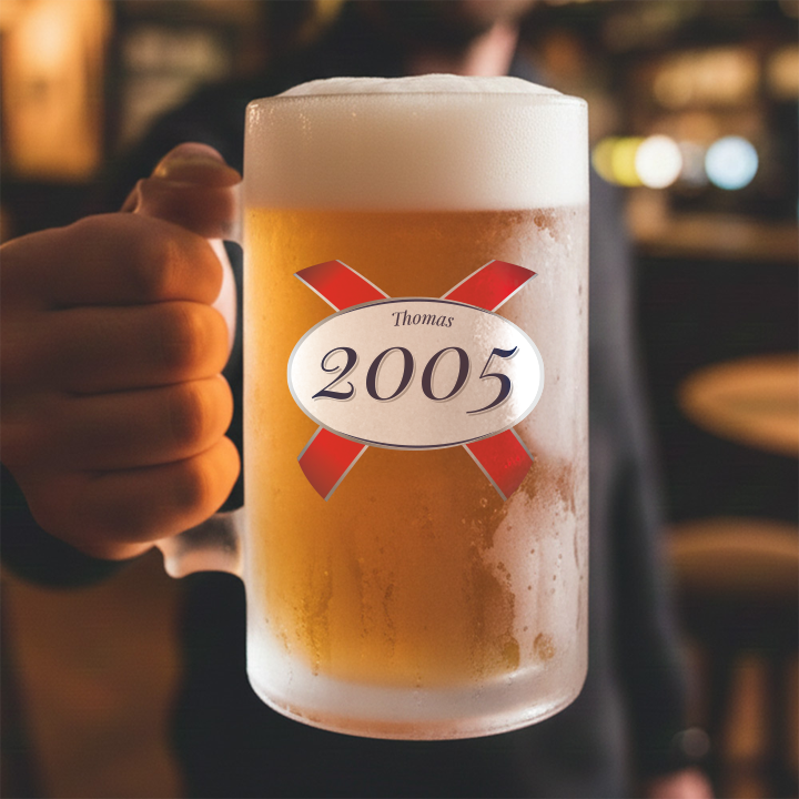 A custom stein with frosted glass and a Kronebourg 1664 design where the 1664 has been swapped for 2005 and has the custom text Thomas on it