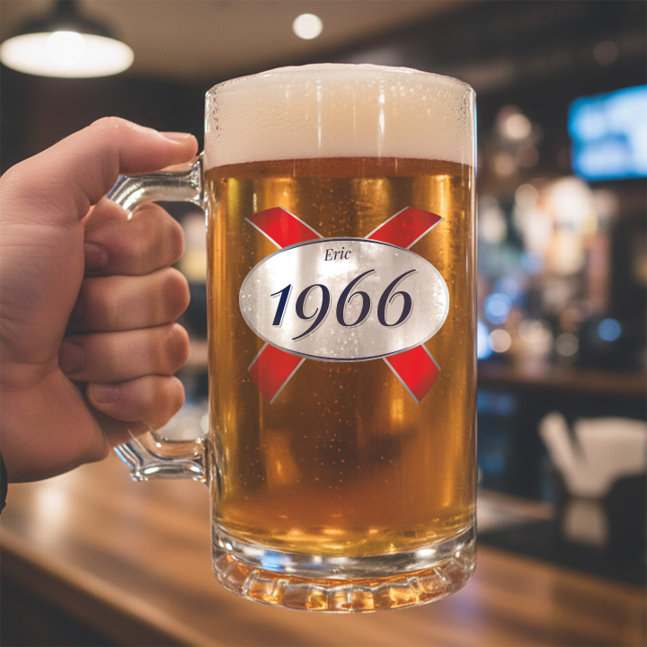 A custom 60th birthday stein with frosted glass and a Kronebourg 1664 design where the 1664 has been swapped for 1966 and has the custom text Eric on it
