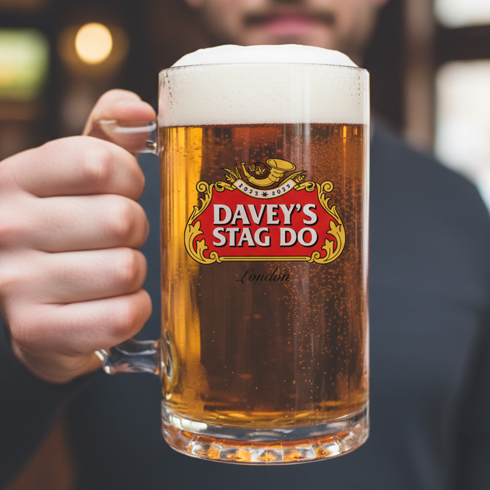 A man holding a custom stella themed stein that has the custom text Davey's Stag Do London