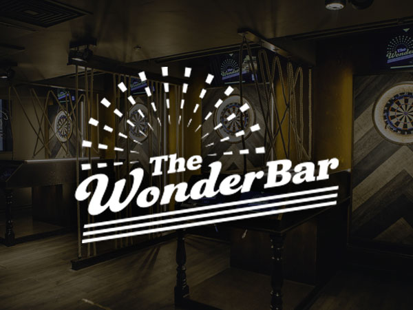 Interior of Wonderbar, a bar with taps and four dart boards