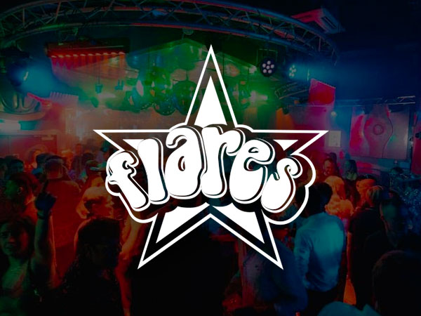 Image of a white beatle car hanging from the ceiling in a bar