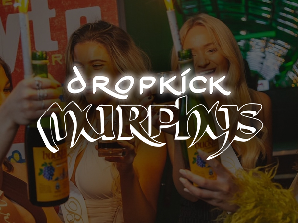 A man playing violin whilst standing on the bar of Dropkick Murphy