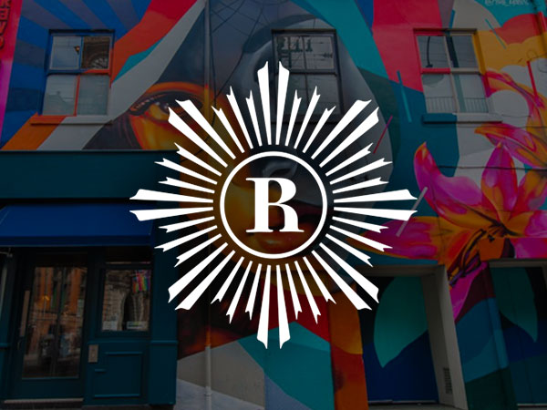 Leather chairs around a circular table with leather seating in the background