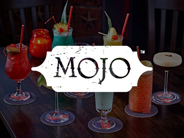 A male bar tender pulling a pint in the bar of Box in Manchester. 