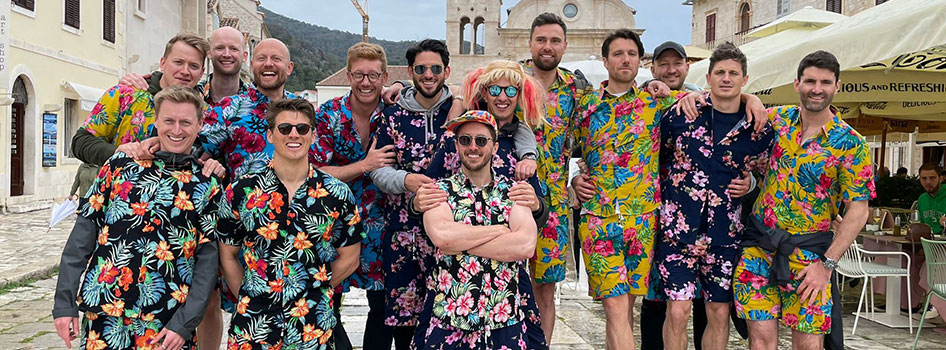 A group of lads wearing hawaiian shirts outdoors in Croatia 