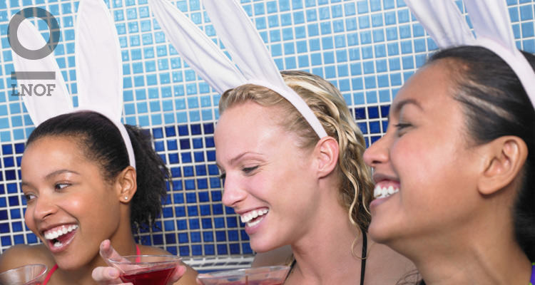 Women wearing bunny ears and drinking cocktails