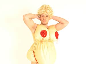 A man posing in a women's fatsuit and wig