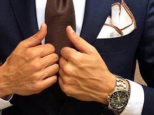 Close up of suave suit and tie and expensive watch
